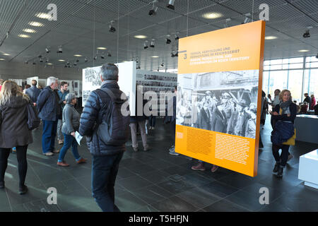 Berlin Germany - visitors inside the Topography of Terror museum view photographs and artefacts from the Nazi era Stock Photo