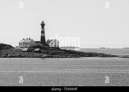 Black And White Photo Of The Remote Norwegian Landegode Lighthouse (Landegode Fyr), located on Eggløysa, About 100 Km North Of The Arctic Circle. Stock Photo