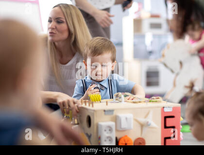 Babies playing in day care centre or nursery Stock Photo