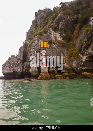 Solar powered lighthouse on karst rock formation in Ha Long Bay, Vietnam. Stock Photo