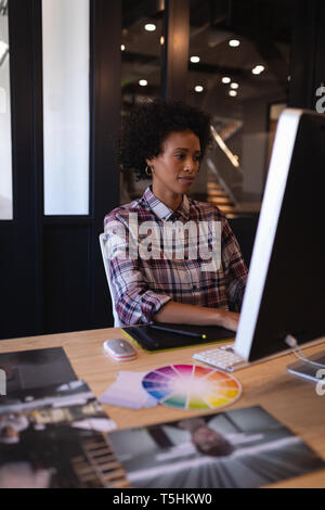 Female graphic designer working on computer in office Stock Photo