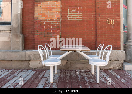 White chairs and table on wooden platform Stock Photo
