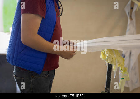 Man making a surfboard in workshop Stock Photo