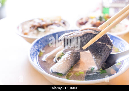 Milkfish skin soup, distinctive Taiwan delicacy food in Tainan. Famous meal set for lunch or breakfast with vegetable, top view, copy space, close up Stock Photo