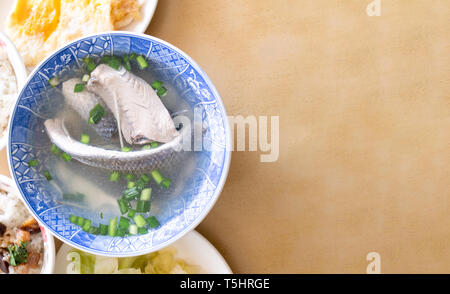 Milkfish skin soup, distinctive Taiwan delicacy food in Tainan. Famous meal set for lunch or breakfast with vegetable, top view, copy space, close up Stock Photo