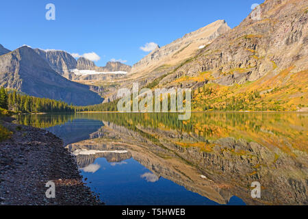 Fall Reflections in Early Morning on Lake Josephine in Glacier National Park in Montana Stock Photo