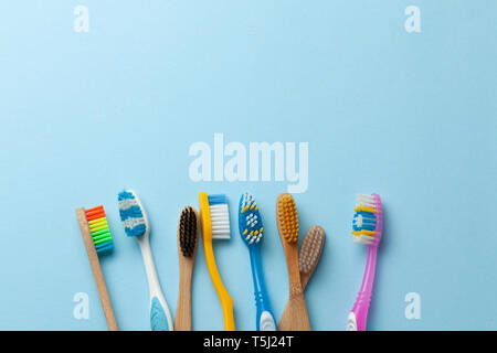 Colored toothbrushes on blue background. Copy space for text Stock Photo
