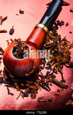 virgin tobacco Tobacco pipe with tobacco and scattered virgin tobacco Stock Photo
