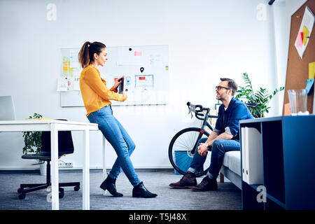 Two colleagues with tablet meeting in office Stock Photo