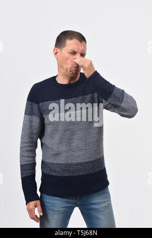 man who covers his nose with his fingers because it makes an smell bad Stock Photo