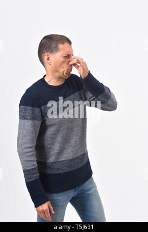 man who covers his nose with his fingers because it makes an smell bad Stock Photo