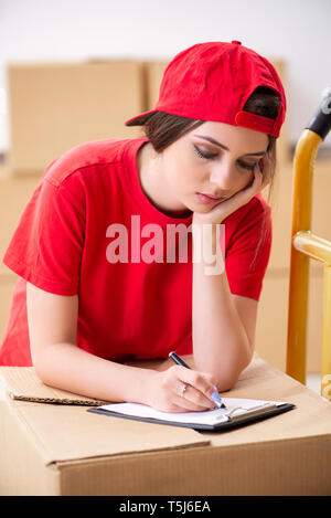 Young female professional mover doing home relocation Stock Photo