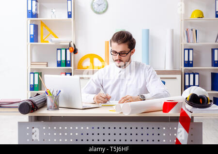 Young male architect working in the office Stock Photo