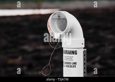 Outdoor fishing line disposal bin there a Lagoon in Chicago's Washington  Park Stock Photo - Alamy