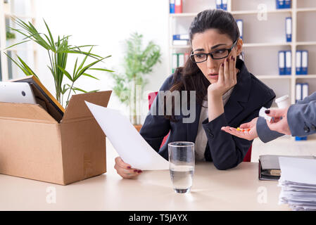 Young female employee being fired from her work Stock Photo