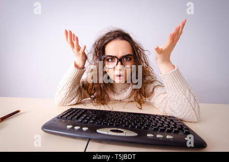Funny nerd girl working on computer Stock Photo