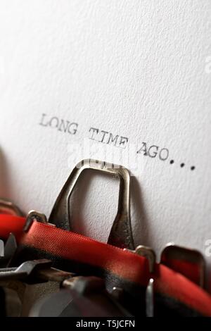 The sentence, long time ago, written with a typewriter. Stock Photo