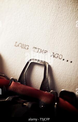 The sentence, long time ago, written with a typewriter. Stock Photo