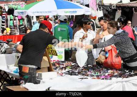 Shoppers going through the stalls at Barking Town Centre Market. East London. 24,4.2010. Stock Photo