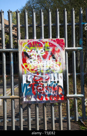 Graffiti on a sign at the gate of the ruined St Peters Seminary, Cardross, Scotland. Save St Peters.  Architects Gillespie, Kidd and Coia designed the Stock Photo