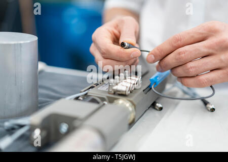 Close-up of man working on workpiece in a factory Stock Photo