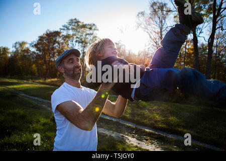 Father playing with his little son  outdoors Stock Photo