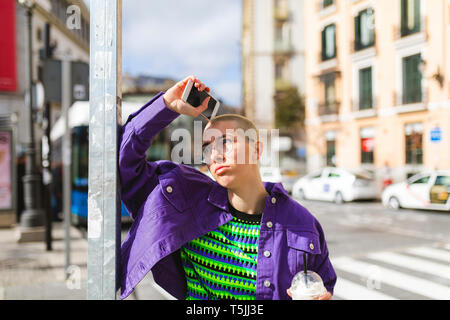 Thoughtful portrait of a young woman in the city Stock Photo
