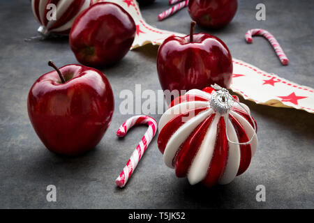 Christmas apples, candy canes and decoration Stock Photo