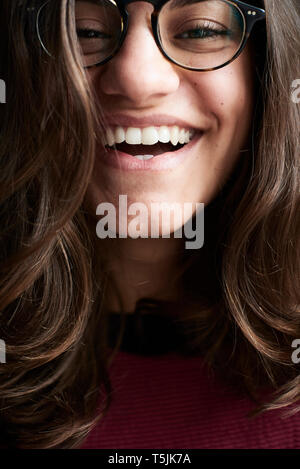 Portrait of laughing young woman wearing glasses Stock Photo