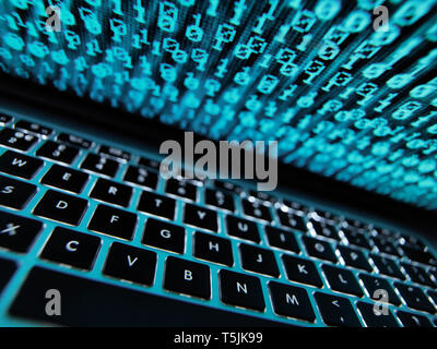 Computer virus infecting a laptop computer with a virus Stock Photo