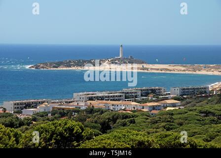 Elevated view of the beach and lighthouse with kite surfers in the bay, Cape Trafalgar, Cadiz Province, Andalusia, Spain. Stock Photo