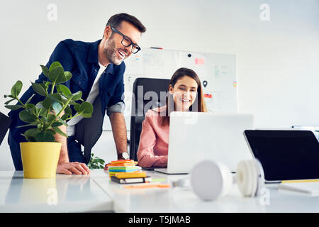 Two colleagues working together on laptop in office Stock Photo