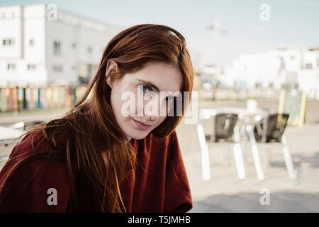 Spain, Canary Islands, Fuerteventura, portrait of redheaded young woman with nose piercing Stock Photo