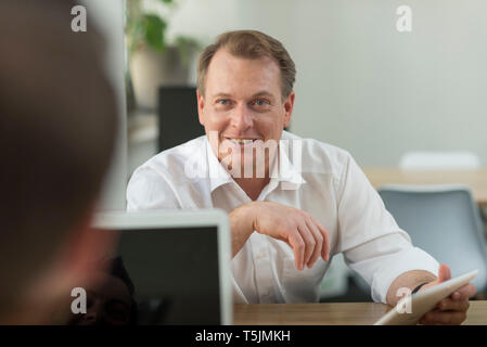 Two businessmen working with tablet in office Stock Photo