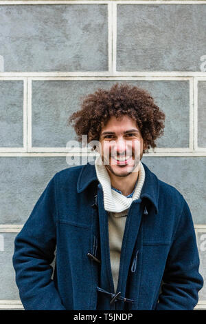 Portrait of happy young man with curly hair Stock Photo