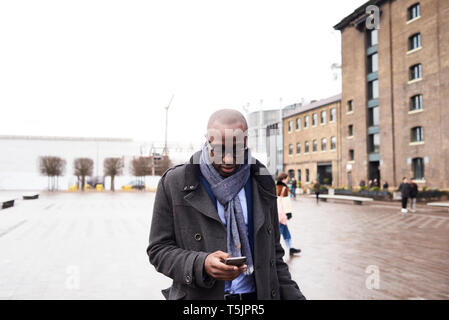 Businessman looking at mobile phone Stock Photo