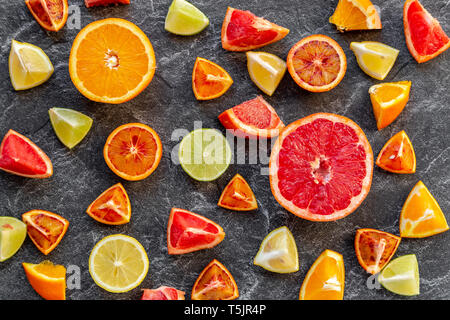 Sliced citrus fruits on slate Stock Photo