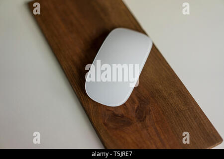 Computer mouse on wooden board on a desk Stock Photo