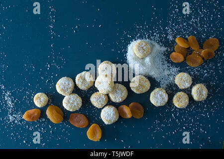 Christmas Cookies with apricots, dried apricots and coconut flakes on blue wood Stock Photo