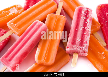 Orange and strawberry popsicles isolated on white background.. Stock Photo