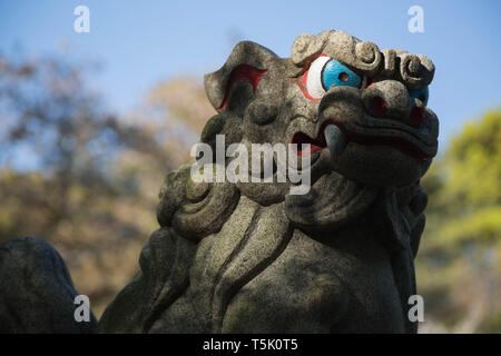 A partially painted foo dog called 'koma inu' among japanese people guarding the premises of Maginu shrine located in Kawasaki, Japan. Stock Photo