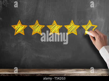 excellent five star customer feedback or client service rating on blackboard Stock Photo