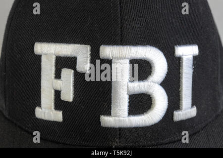 Close up of the FBI logo on a black cap. The text stands for Federal Bureau of Investigations. Frontal view. Stock Photo