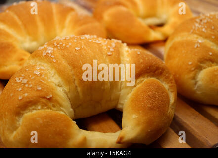 Closed up fresh baked sugar coated croissants on the wooden tray Stock Photo