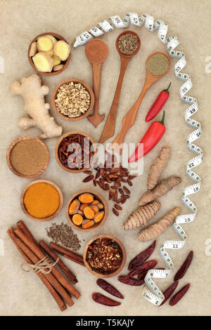 Spices for slimming and weight loss with fresh and dried turmeric, cumin, ginger, chilli, cinnamon and gymnema sylvestre used to suppress appetite. Stock Photo