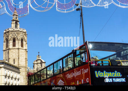 Valencia Spain City center Sightseeing tour bus Double-decker on Plaza de la Reina, Valencia Cathedral Tower background Valencia tourism Stock Photo