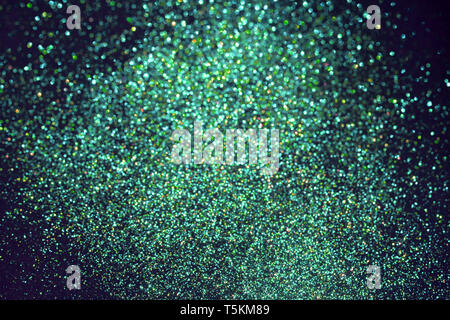 Vibrant green blurred sparkling glittering background. Festive backdrop. Stock Photo