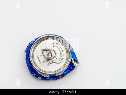 Crushed compressed aluminum carbonated drink can. Pollution, waste, ecology. Stock Photo