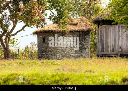 Stone wall house and wooden house with beautiful background,chiwan Nepal Stock Photo