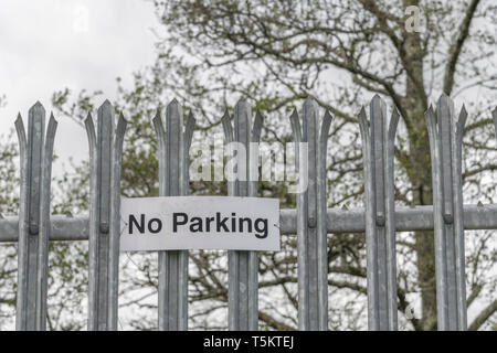 No  Parking sign on the fence of an industrial estate, Metaphor 'rules', 'obey'. Stock Photo
